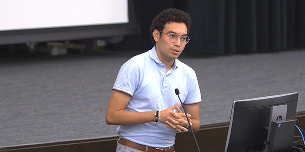 Image of student presenting at a podium during a previous pitch competition.